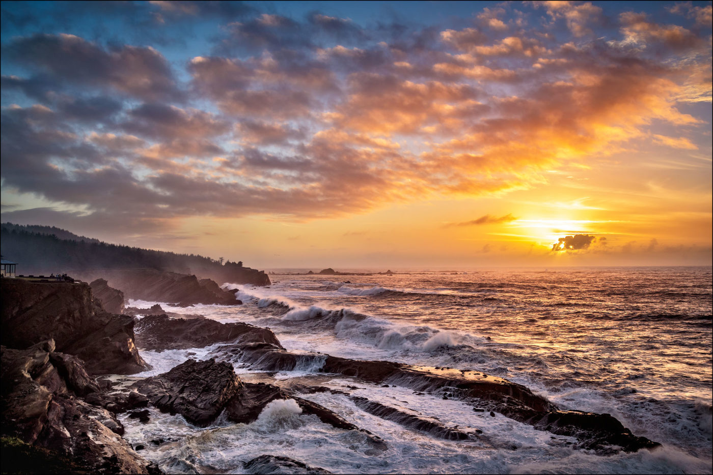 Sunset and storm surf at Shore Acres State Paråk on the southern Oregon coast.