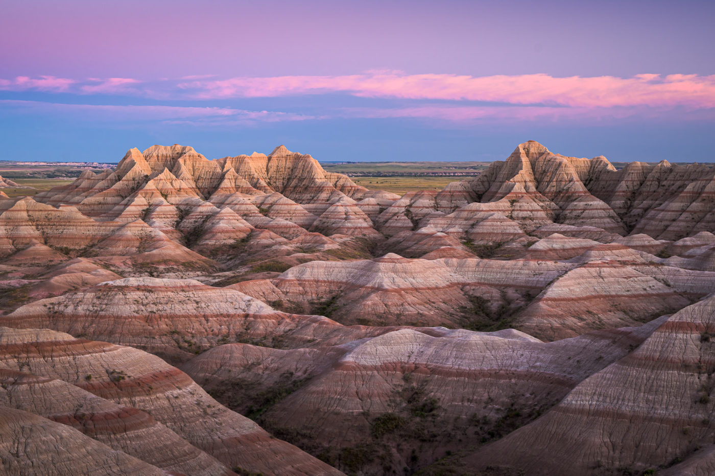 Dusk over the striated pinnacles and gullies of Badlands National Park in South Dakota, USA.