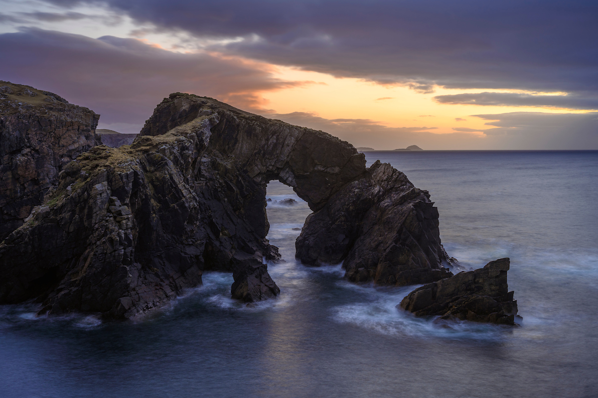 natural arch in a rocky headland on the coast