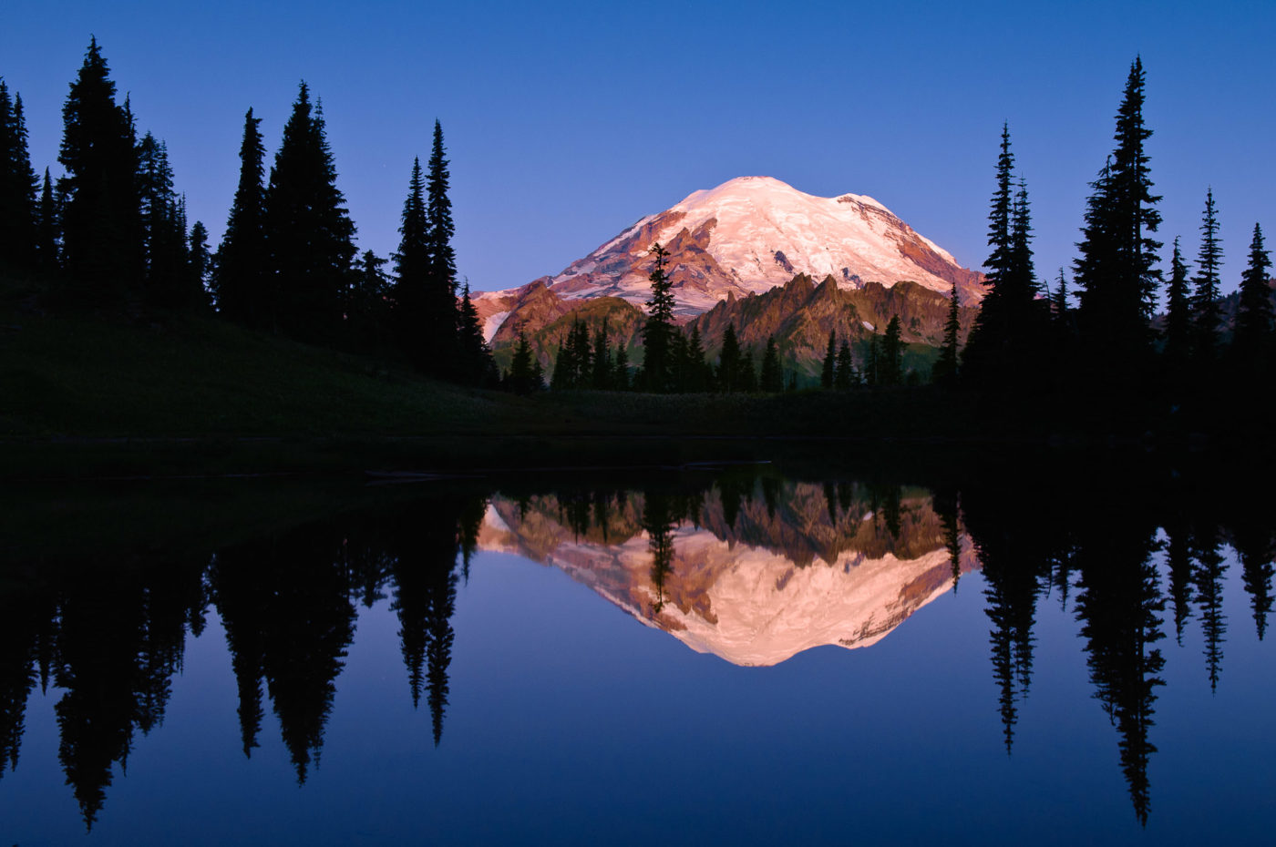 Mount Rainier and reflection in Upper Tipsoo Lake at sunrise;